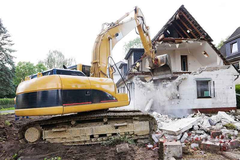 Machine demolishing an old home