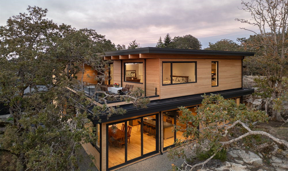modern home among rock and tree coverage