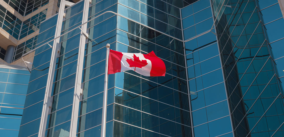 Canadian flag in front of buildings